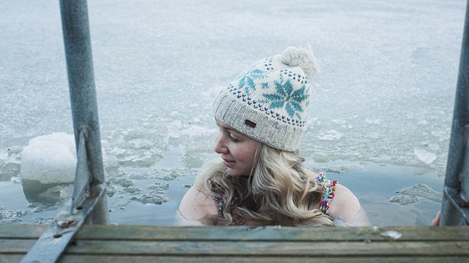 Person in icy water wearing hat