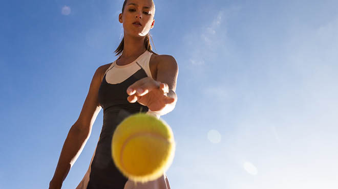 Player bouncing tennis ball