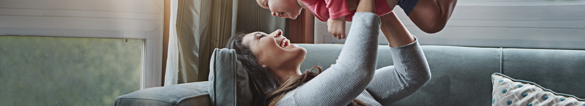 lady lifting baby in air