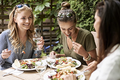 Young women eating lunch on restaurant patio
