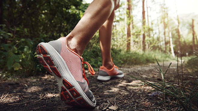 Running shoes on a wooded trail