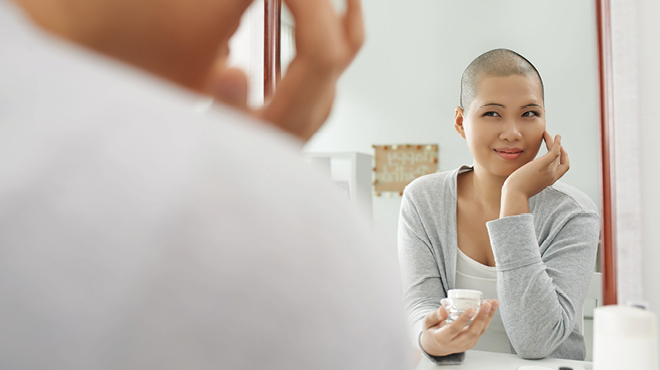 Woman with close hair looking in mirror