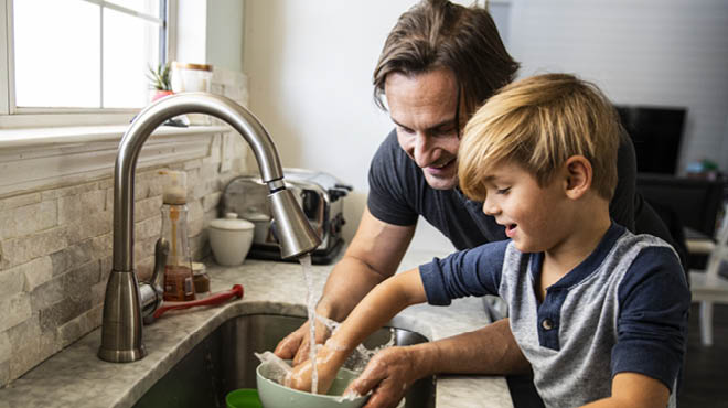 Dad and child washing dish