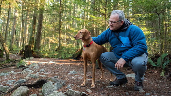 Dog and owner in the woods