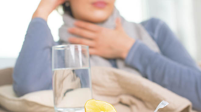 Hand on throat, glass of water nearby