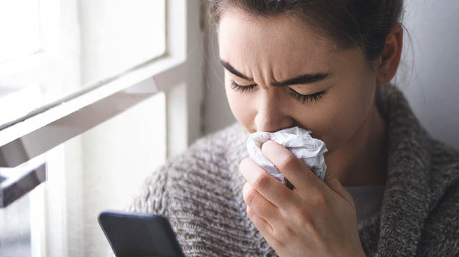 Holding tissues to nose