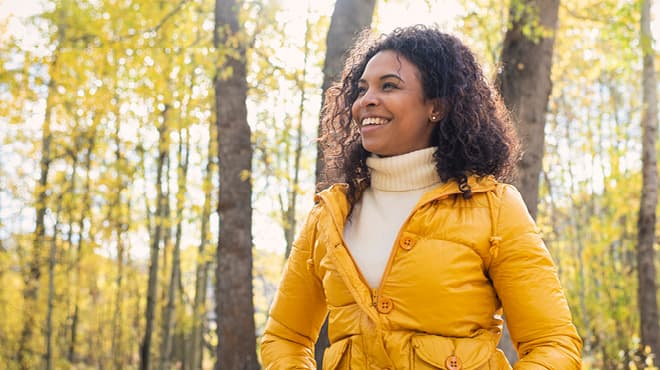 In woods wearing yellow jacket