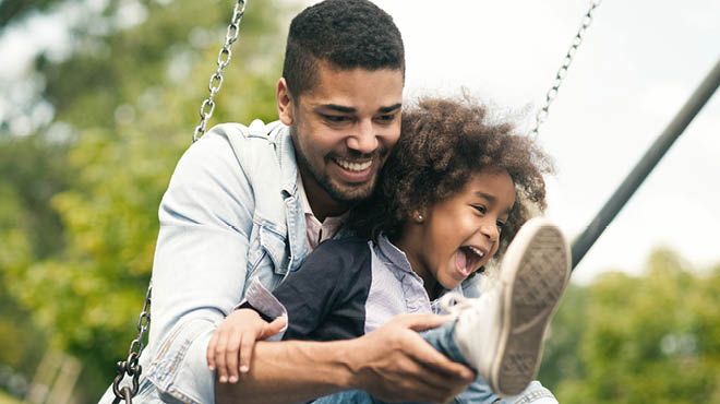 Parent and child on swing