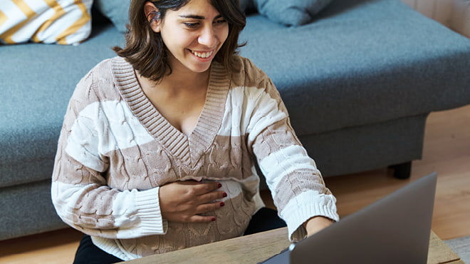 Pregnant woman using laptop