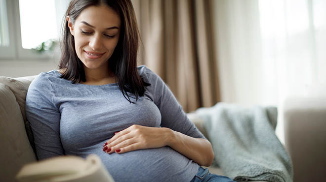 Pregnant women hand on belly