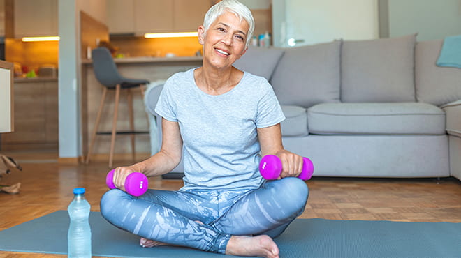 Senior woman working out at home