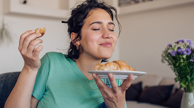 Smelling plate of food