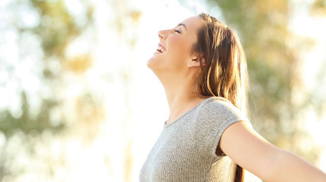 Smiling open arms in outdoors