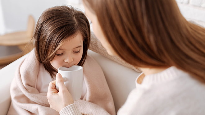 Young child sipping on cup