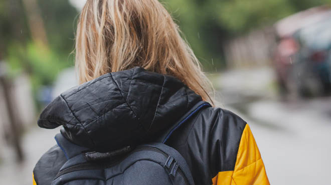 Back of student wearing backpack