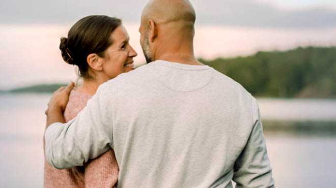 Couple smiling near waterfront