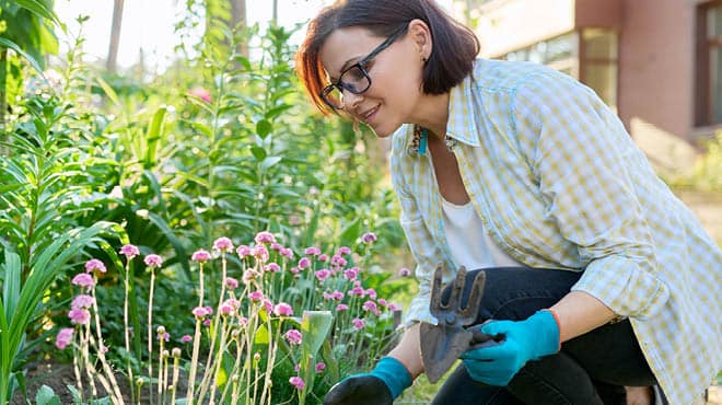 Crouching while flower gardening