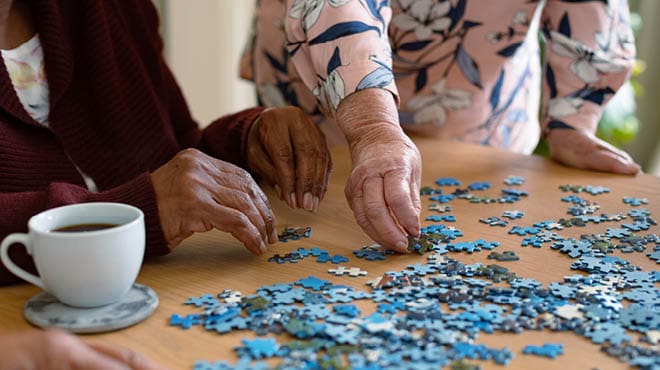 Hands sorting puzzle pieces