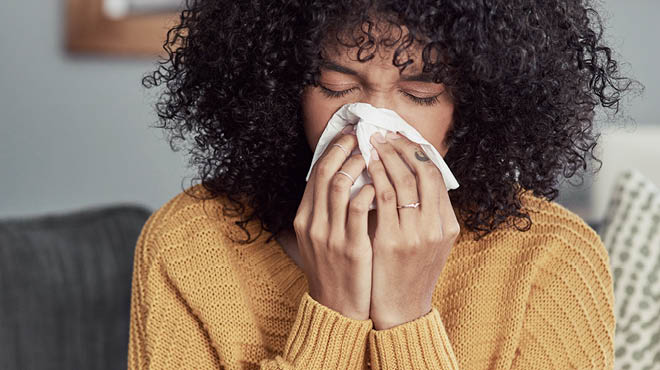 Holding tissue against nose