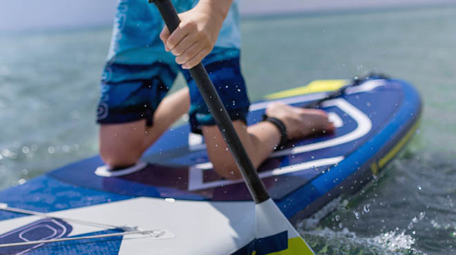 Kneeling on paddleboard