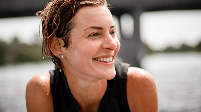 Person wet from swimming and smiling