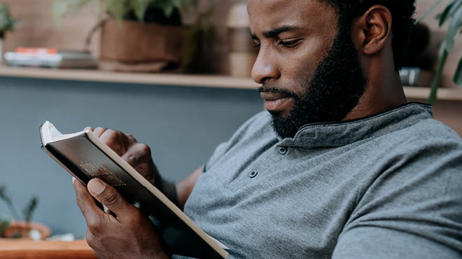 Bearded man reading book