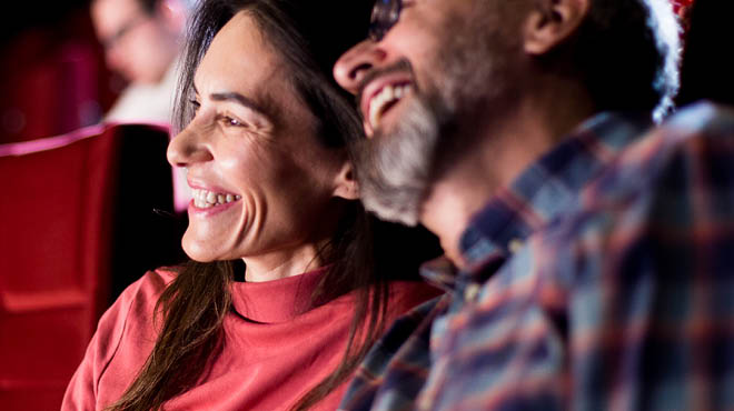 Couple laughing watching performance