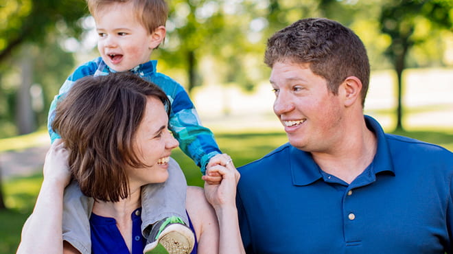 Couple with toddler on shoulders