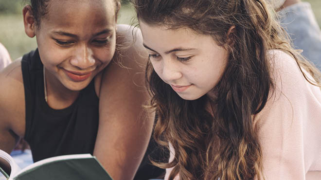 Kids reading a book together