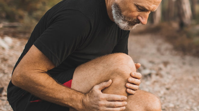 Person holding leg joint