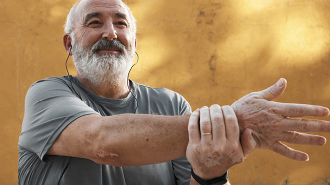 Person holding wrist with hand