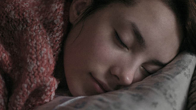 Person napping with head on pillow