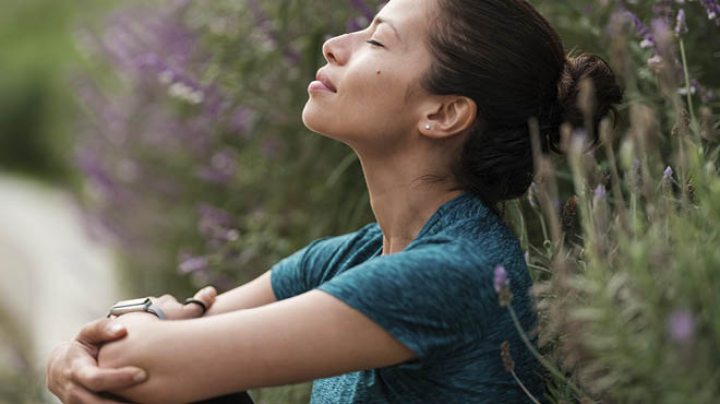 Person purposefully relaxing, sitting with eyes closed