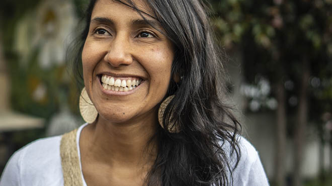 Smiling person wearing large earrings