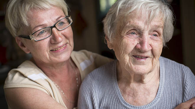 Two people embracing and smiling.