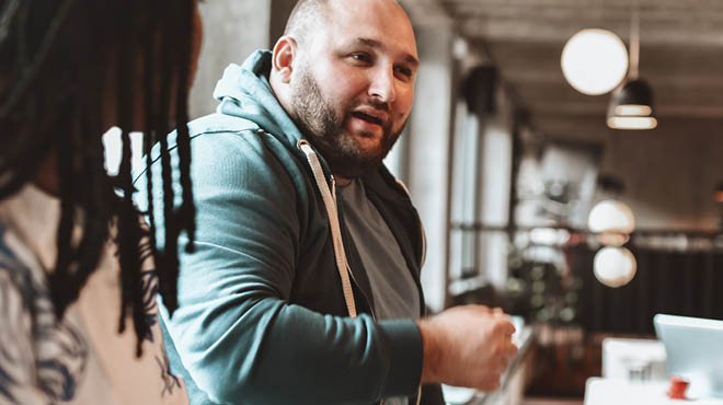 Two people talking indoors