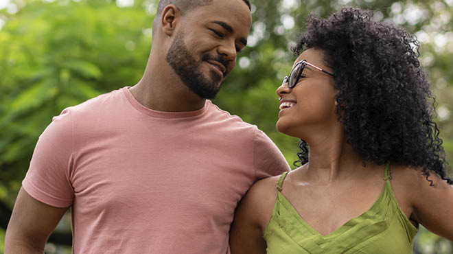 Young couple smiling arm in arm