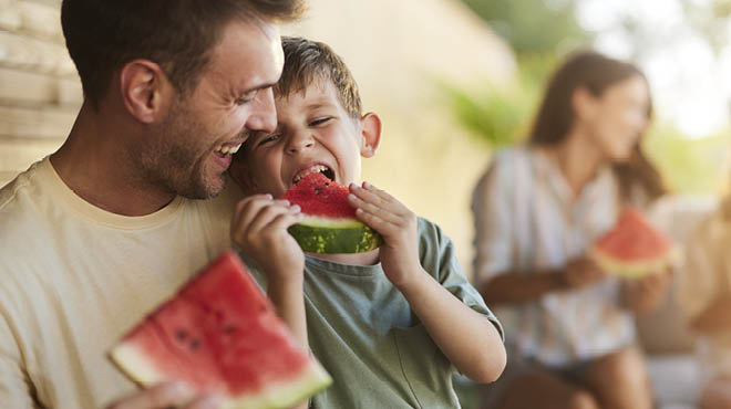 Family eating watermelon