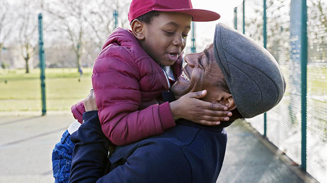 Parent lifting young child