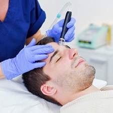 Man having cosmetic procedure done on forehead